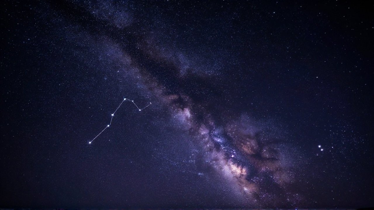 Cielo nocturno invernal estrellado con el cinturón de Orión y el resplandor de la Vía Láctea.